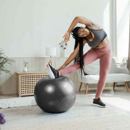Ballon pilates gris femme fait des exercices a la maison